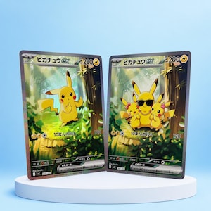 May include: Two rectangular trading cards featuring Pikachu ex with 200 HP. The left card shows a single yellow Pikachu in a forest. The right card shows three yellow Pikachu characters, one wearing sunglasses and a chain. Both cards display Japanese text.