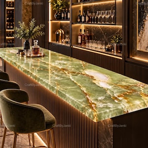 May include: A long bar counter featuring a polished green onyx surface with prominent white and amber veining. The counter is supported by a dark, vertically slatted base and is accompanied by several matching green velvet upholstered bar stools.