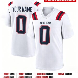 May include: A white jersey with navy blue and red accents on the shoulders. The front displays the text YOUR TEAM and the number 0 in navy blue with red outlines. The back features the text YOUR NAME and the number 0 in navy blue and red.