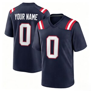 May include: A navy blue short-sleeve jersey featuring a V-neck collar and white stripes with red borders on the shoulders. The front displays a large white number zero with a red outline. The back shows the text YOUR NAME above a large number zero.