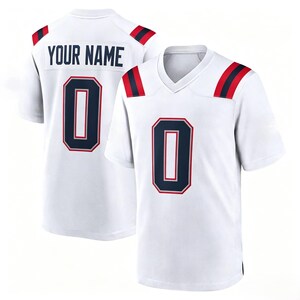 May include: A white short-sleeved jersey featuring a V-neck collar, navy blue and red shoulder stripes, and the number 0 in navy blue with a red outline on the front. The back displays the text YOUR NAME above the navy blue number 0.