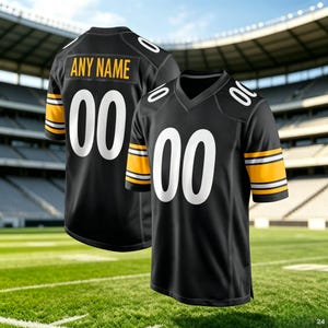 May include: A black football jersey featuring white numbers 00 on the front and shoulders, with yellow and white stripes on the sleeves. The back displays the text ANY NAME in yellow above the large white number 00. The jersey has a V-neck collar.