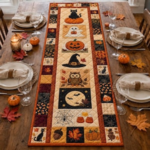 May include: A rectangular quilted table runner featuring a central column of Halloween-themed squares including a black cat on a pumpkin, a ghost, a jack-o'-lantern, a witch hat, an owl, a full moon with bats, a spider web, and candy corn.
