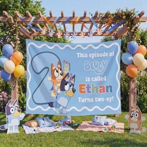 May include: A light blue rectangular party backdrop featuring the cartoon characters Bluey and Bingo, the large number 2, and the text This episode of Bluey is called Ethan Turns two-ey! The banner is decorated with a scalloped white border.