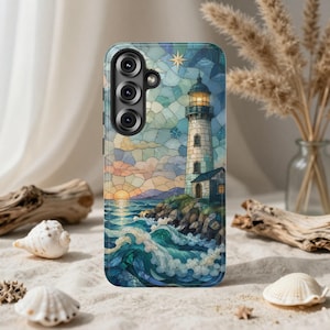 May include: A smartphone case featuring a stained glass style illustration of a lighthouse on a rocky cliff overlooking a turbulent ocean at sunset. The design includes a glowing sun, crashing blue waves, and a star in the sky above the lighthouse.