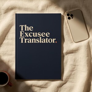 May include: A dark navy blue hardcover book with the title The Excusee Translator. printed in a cream-colored serif font on the front cover, accompanied by a small orange dot at the end of the text, positioned next to a gold smartphone.