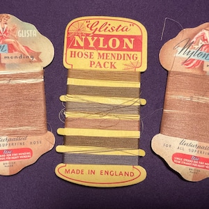 May include: Three vintage Glista nylon mending thread cards. Two identical cards feature a tan thread with a woman illustration and text reading Nylon mending and Unsurpassed for all superfine hose. The center card holds multi-colored thread.