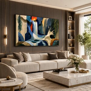 May include: A large rectangular wall art piece featuring an abstract landscape painting with a central waterfall, deep blue and white water splashes, and accents of orange, yellow, and dark green, displayed in a black frame above a beige sofa.
