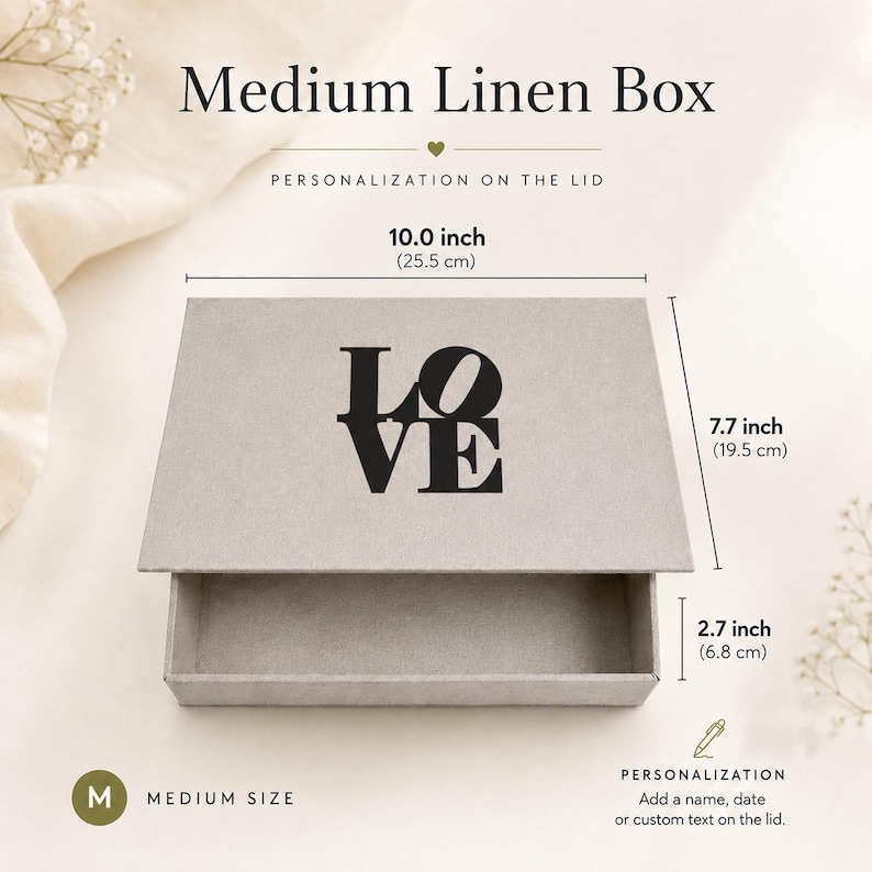 May include: A medium linen box with a gray finish and the word LOVE printed in black on the lid. The box measures 10.0 inches wide, 7.7 inches deep, and 2.7 inches high. The text Medium Linen Box and Personalization on the lid are visible.