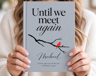 Könnte beinhalten: Ein hellgraues Hardcover-Buch mit dem schwarzen Text Until we meet again, einer schwarzen Baumzweig-Illustration, einem kleinen roten Kardinalvogel, dem Namen Michael in Schreibschrift und dem Text A little space for all the love I still have to give.
