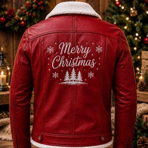 May include: A red leather jacket with a white faux-shearling collar and hem. The back features white embroidered text that reads Merry Christmas, surrounded by snowflake and pine tree designs. The jacket has long sleeves with zippered cuffs.