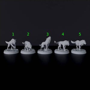 May include: Five grey miniature wolf figurines standing on circular stone-textured bases, labeled with green numbers one through five. Each wolf is depicted in a different pose, including crouching, howling, and walking, with detailed fur textures.