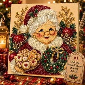 May include: A square diamond painting art kit featuring a beaded illustration of Mrs. Claus wearing a red hat and glasses, holding a plate of cookies and a wreath. A small sign in the corner reads #1 Christmas Pearl Diamond Painting Art Kit.