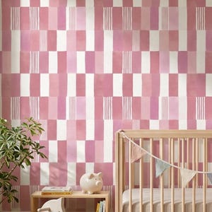 May include: Wallpaper featuring a repeating geometric pattern of vertical rectangles in shades of pink, white, and mauve, with some rectangles containing thin white vertical stripes, creating a textured, block-like visual effect on the wall.