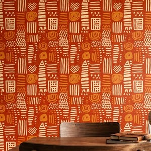 May include: A vibrant orange wallpaper featuring a repeating pattern of cream-colored hand-drawn shapes, including vertical lines, zigzags, circles, and rectangular grids. The design covers the entire surface with a dense, rhythmic arrangement.