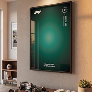 May include: A framed vertical poster featuring a dark green gradient background with the white F1 logo at the top left, the Mercedes-AMG Petronas logo at the top right, and the text Mercedes-AMG W14 E Performance printed at the bottom center.