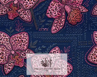 May include: A dark blue fabric pattern featuring embroidered pink orchids with leopard print spots, accented by small stitched leaf motifs and cross-stitch details. A logo reads Timeless Pattern House, and a label indicates 13 inches by 13 inches.