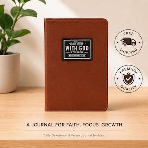 May include: A brown leather-like journal featuring a rectangular black patch on the front cover with white text that reads: ALL THINGS WITH GOD FOR MEN PHILIPPIANS 4:13. The journal has rounded corners and a smooth, solid-colored exterior finish.