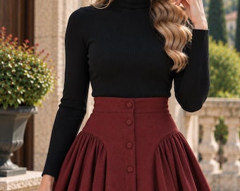 May include: A black long-sleeved ribbed turtleneck jumper paired with a high-waisted, deep burgundy midi skirt featuring a central vertical row of matching fabric-covered buttons and gathered pleats at the sides, accompanied by a small black handbag.