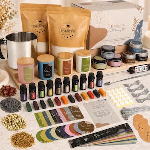 May include: A candle making kit featuring a stainless steel pouring pitcher, two 1.5lb bags of wax, candle jars with wooden lids, fragrance oils, dye blocks, wicks, wick centering tools, a digital thermometer, and various labels and instruction cards.