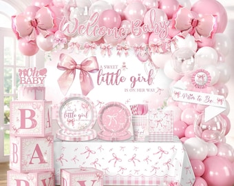 May include: A baby shower party set featuring pink and white balloons, a backdrop with the text Welcome Baby and A sweet little girl is on her way, a table cover with bow patterns, paper plates, cups, napkins, and four large blocks spelling BABY.