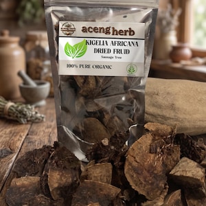 May include: A clear plastic stand-up pouch containing brown, dried pieces of Kigelia Africana, also known as Sausage Tree fruit. The label features the text aceng herb, KIGELIA AFRICANA DRIED FRUID, Sausage Tree, and 100% PURE ORGANIC.