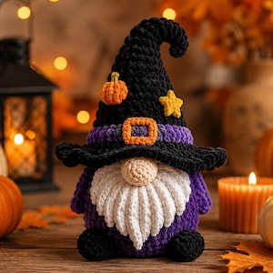 May include: A crocheted gnome figurine wearing a tall black witch hat with a purple band, an orange buckle, a small orange pumpkin, and a yellow star. The gnome has a round beige nose, a long white beard, a purple body, and black feet.