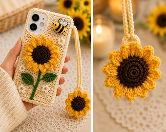 May include: A beige crochet phone case featuring a large yellow sunflower with a dark brown center, green leaves, small white flowers, and a small bee applique. A matching sunflower charm hangs from a long, braided beige crochet wrist strap.