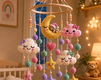 May include: A crochet baby mobile featuring a yellow crescent moon with a small bear, pink and white clouds with bows, colorful stars, and small spheres suspended from a circular wooden frame with wooden and pastel-colored beads on white strings.