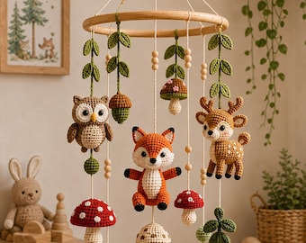 May include: A hanging mobile featuring crocheted woodland animals and plants suspended from a circular wooden frame. The mobile includes a brown owl, an orange fox, a spotted deer, various red and beige mushrooms, green leaves, and wooden beads.