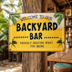 May include: A rectangular metal sign with a yellow background and white border. The text reads: WELCOME TO OUR BACKYARD BAR PROUDLY SERVING WHAT YOU BRING. The sign features green palm leaf illustrations in the corners and dark blue lettering.