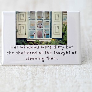 May include: A white ceramic tile with a picture of a window and the text "Her windows were dirty but she shuttered at the thought of cleaning them."