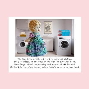 May include: A vintage doll with blonde hair and a colorful crocheted dress stands in a laundry room. The doll is positioned in front of a washing machine. Text at the bottom reads: "The tidy little whirlwind tried to wash her clothes..."