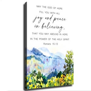 Könnte beinhalten: Ein rechteckiges Leinwandbild mit einer Aquarell-Landschaft aus blauen Bergen und gelb-grünem Blattwerk am unteren Rand. Der Text lautet: MAY THE GOD OF HOPE FILL YOU WITH ALL joy and peace in believing, THAT YOU MAY ABOUND IN HOPE IN THE POWER OF THE HOLY SPIRIT Romans 15:13.
