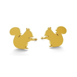 May include: A pair of gold-colored squirrel stud earrings. The squirrels are facing to the right and have their tails curled up behind them.