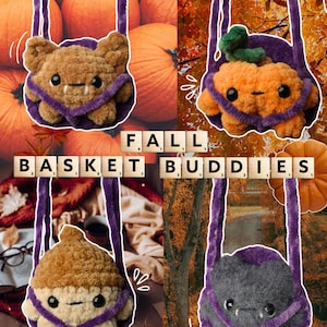 May include: Four plush crochet baskets with purple straps, each featuring a different character: a brown bat, an orange pumpkin, a tan acorn, and a gray bat. The text FALL BASKET BUDDIES is displayed in the center using wooden letter tiles.