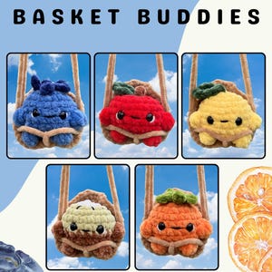 May include: Five plush toys titled THE BASKET BUDDIES by COTTON AND CANDY. Each toy features a crocheted fruit character in a tan basket with straps: a blue blueberry, a red apple, a yellow lemon, a light green kiwi, and an orange.