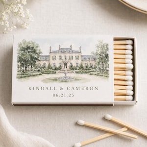 May include: A rectangular matchbox with a white exterior featuring a watercolour illustration of a large estate with a fountain. The text KINDALL & CAMERON and 06.21.25 is printed below the image. The box contains wooden matches with white tips.