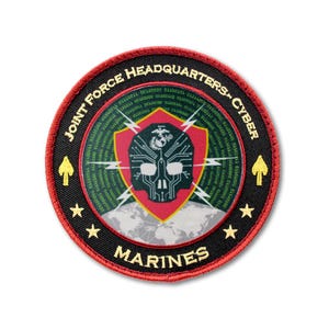 May include: A circular embroidered patch with a red border. The black background features green binary code, a central red shield with a skull and circuit design, a globe graphic, and the text JOINT FORCE HEADQUARTERS CYBER MARINES in gold.