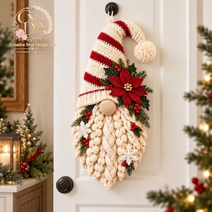 May include: A crochet gnome wall hanging featuring a red and cream striped hat with a pom-pom, a textured cream beard, and a central nose. The gnome is decorated with a red poinsettia, green pine sprigs, red berries, and white snowflake accents.