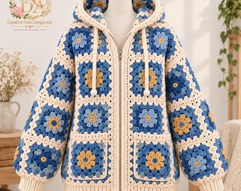 May include: A zip-up hooded jacket made of cream, light blue, and yellow crochet granny squares featuring a floral pattern. The garment includes a front zipper, two square pockets, long sleeves with ribbed cuffs, and a drawstring hood with pom-poms.