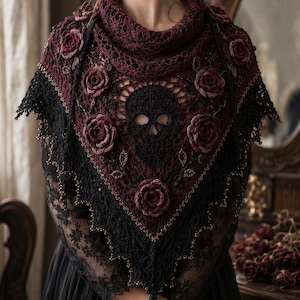 May include: A triangular crochet shawl featuring a dark burgundy and black color scheme. The design includes a central black skull motif surrounded by three-dimensional burgundy roses and leaves, with a delicate beaded scalloped edge.