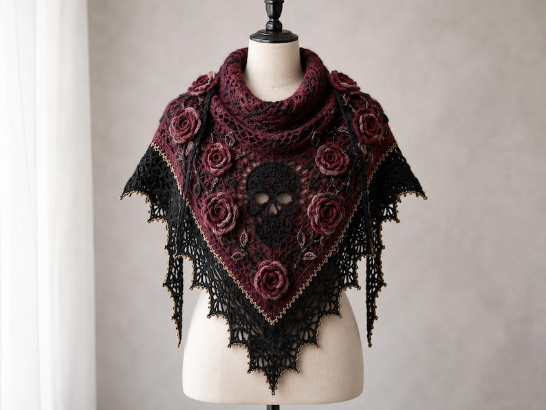 May include: A triangular crochet shawl featuring a deep burgundy and black color scheme. The design includes a central black skull motif surrounded by three-dimensional burgundy roses and intricate lace edges with subtle gold-toned accents.