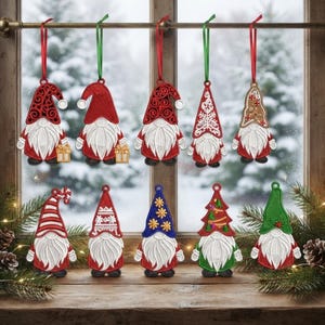 May include: Ten embroidered gnome ornaments featuring white beards and various hats in red, green, blue, and brown. The top row hangs from ribbons, while the bottom row sits on a wooden surface. Designs include snowflakes, stripes, and gifts.