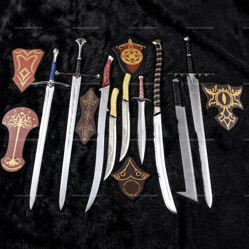 May include: A collection of metal swords and daggers with various blade shapes and hilt designs, accompanied by several decorative wooden wall plaques featuring gold-colored patterns, arranged together on a dark, textured surface.