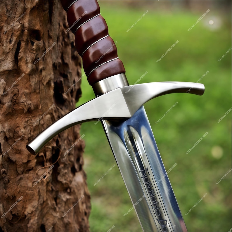 May include: A steel sword featuring a dark brown leather-wrapped grip with white stitching, a polished silver crossguard, and a blade with a central fuller. The blade is engraved with the text "NON NOBIS DOMINE" near the hilt area.