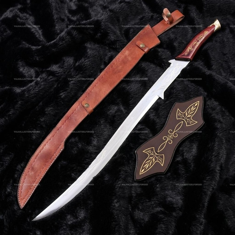 May include: A long, curved sword with a silver-toned blade, a dark reddish-brown wooden handle with gold-colored accents, a brown leather scabbard with metal studs, and a separate dark brown leather sheath piece featuring gold-colored leaf designs.