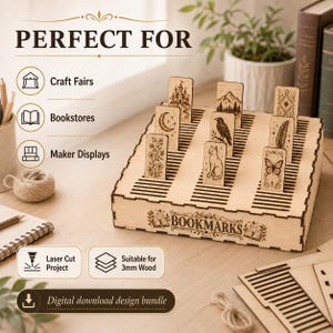 May include: A light-colored wooden display stand featuring multiple slots for holding rectangular bookmarks. The front panel is engraved with the word BOOKMARKS and decorative floral motifs. Several wooden bookmarks with laser-etched designs including a castle, mountain, raven, cat, feather, butterfly, and floral patterns are inserted into the stand.
