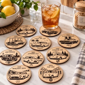 May include: A set of ten circular wooden coasters, each featuring a laser-engraved illustration of a classic car model, including a 1963 VW Beetle, 1969 Chevrolet Camaro, 1957 Chevy Bel Air, 1968 Dodge Charger, 1965 Mini Cooper, 1966 Citro&euml;n 2CV, 1959 Porsche 356, 1955 Mercedes 300SL, and 1964 Fiat 500.