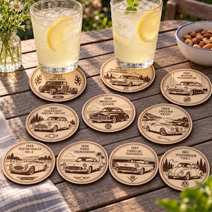 May include: A set of nine circular wooden coasters, each displaying a laser-engraved illustration of a classic car dating from the 1930s to the 1960s, featuring models such as the 1932 Ford Hot Rod, 1950 Plymouth Cranbrook, and 1962 Volkswagen Type 1.